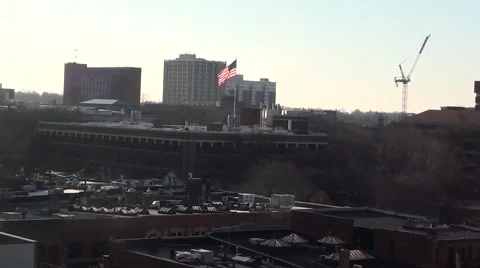 Skyline, Rooftop shot Ann Arbor, Michigan, USA with U.S. Flag waving Stock Footage