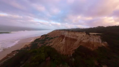 Skyline with soft pastel clouds over cliffside beach. After the storm Video stock 345055276