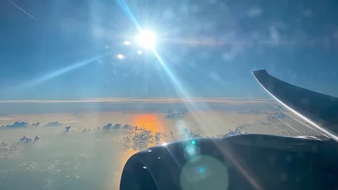 Skyline with Sun view from window of flying Airplane Stock Footage 121260511