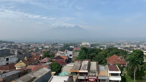 Skyline view of Bogor City, Java, Indonesia. Mount Salak in the background. Stockbeeldmateriaal 106142129
