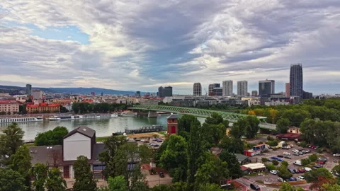 Skyline view of a city with buildings and a river during the day with clouds in Stock Footage 340945053