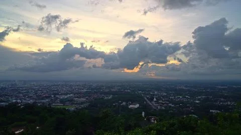 Skyline view of city with dramatic clouds at sunset Stock Photos