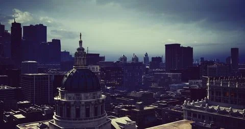 Skyline view of a city under dramatic clouds during twilight Stock Illustration