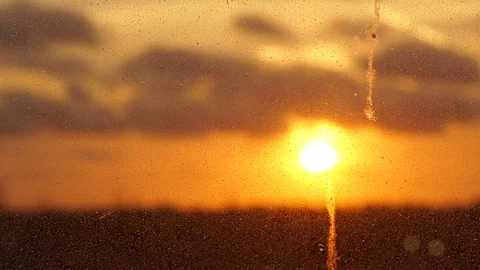 Skyscape with yellow setting sun and dark floating smoke Stock Footage 115884773