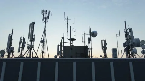 Skyscraper antennas and communication radars on building rooftop, aerial Stock Footage 138337481