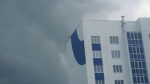 Skyscraper on the background of the rainy clouds Stock Footage 75913755