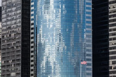 Skyscraper background with US flag in New York City Stock Photos