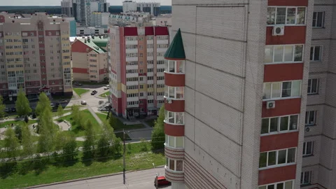 Skyscraper balcony facing tranquil courtyard with decorative brick wall Stock Footage 335764893