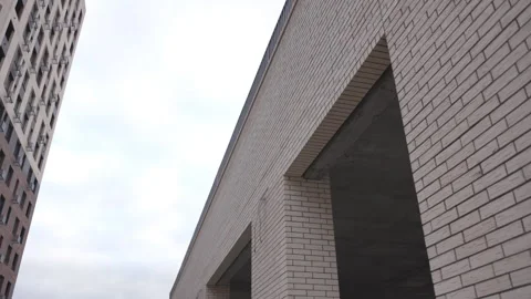 Skyscraper beside incomplete structure with open sections Stock Footage 303108221