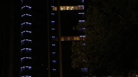 Skyscraper with blue lights at night in Paris. Close Up, Tilt Up. People passing Video stock 110915959