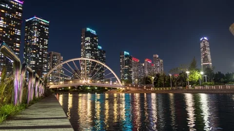 Skyscraper building with bridge illumination on songdo river in central par.. Stock Footage 256100135