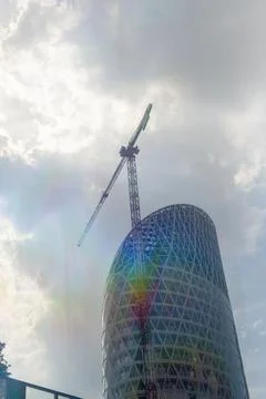 Skyscraper building under construction with light flare Stock Photos