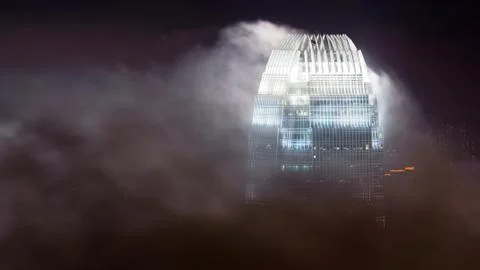 Skyscraper in clouds Stock Photos