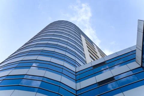 Skyscraper with clouds reflection Stock Photos