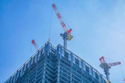 Skyscraper construction crane and blue sky Stock Photos