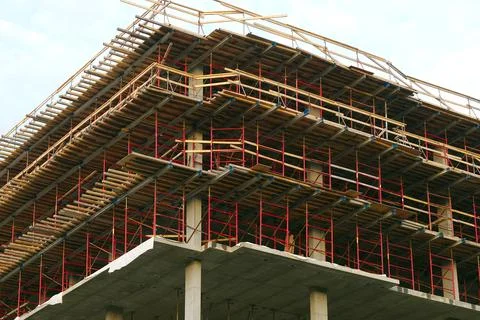 Skyscraper construction site building structure wood beams and concrete frame Stock Photos
