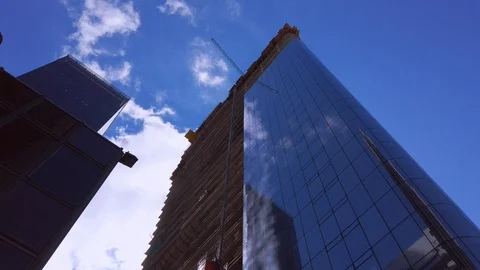 Skyscraper construction site. High office building with blue sky from below. Stock Footage 108306376
