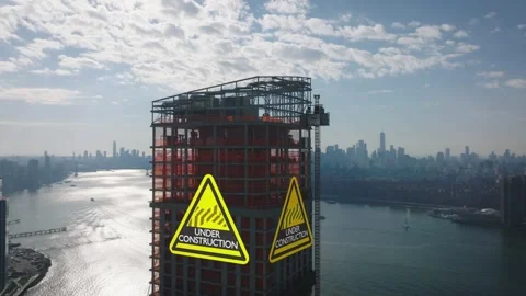 Skyscraper Construction Site with Warning Signs over City Skyline View 库存影片 331045777