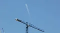 Skyscraper, cranes and tallness - 1 - jet fly by with contrails HD Footage