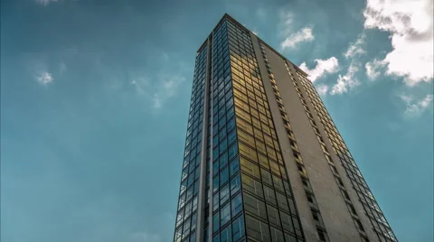 Skyscraper. Drifting clouds reflect in the windows of office buildings. Video stock 54664244