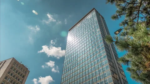 Skyscraper. Drifting clouds reflect in the windows of office buildings. Video stock 54664689