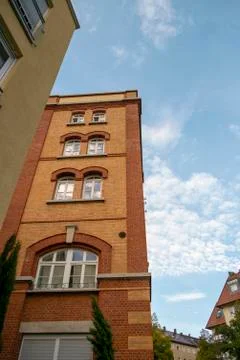 Skyscraper with a facade of bricks against a blue sky Stock Photos