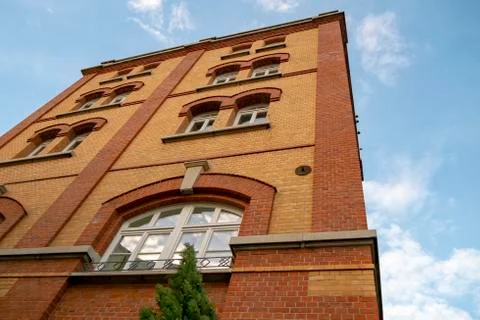 Skyscraper with a facade of bricks against a blue sky Stock Photos