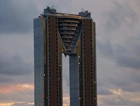 Skyscraper with glowing windows, modern tower featuring illuminated windows and Stock Photos