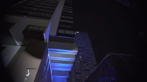 Skyscraper Modern building Blue architecture at night with light spots at Stock Footage 119365671