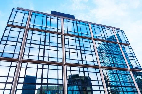 Skyscraper with numerous windows under a clear blue sky Stock Photos