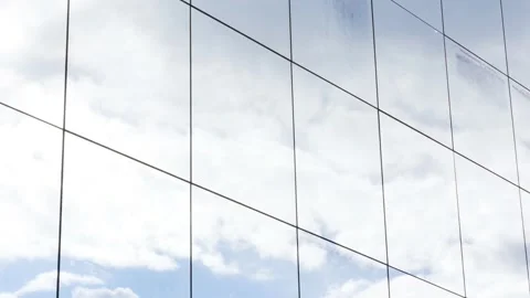 Skyscraper office building glass square windows blue cloudy sky reflection Stock Footage 151281785
