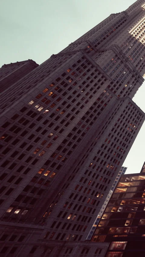 Skyscraper reaching high under evening sky in urban setting Stock Footage 342189334