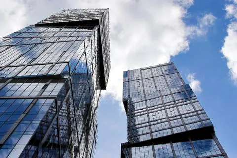 The skyscraper with the reflection of the blue sky in the Windows Stock Photos