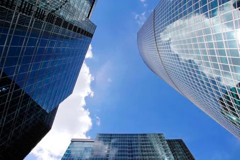 The skyscraper with the reflection of the blue sky in the Windows Stock Photos