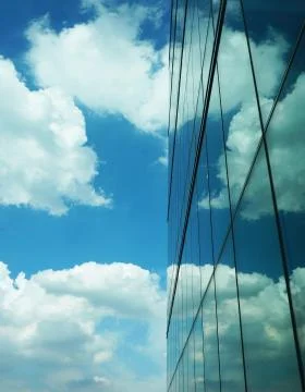 Skyscraper with reflection heart shape of clouds Stock Photos