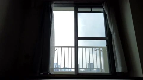 A skyscraper seen from the window of vacant studio apartment and curtains swa Video stock 203919039