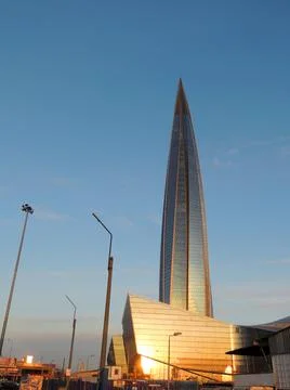 A skyscraper in the shape of a corn on the background of a blue sky at sunset Stock Photos
