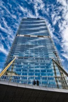 A skyscraper Is standing under a Blue cloudy sky in City Life, Milan Stock Photos