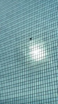 Skyscraper in Sun with Cloud in Background Stock Photos