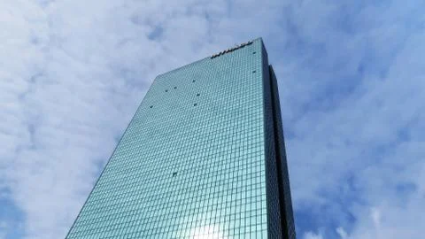 Skyscraper in Sun with Cloud in Background Stock Photos