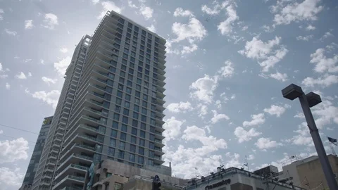Skyscraper in Tel Aviv with airplane in sky Stock Footage 86043766