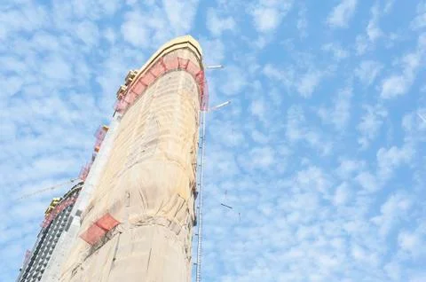 Skyscraper under construction, covered with drop cloths. Stock Photos