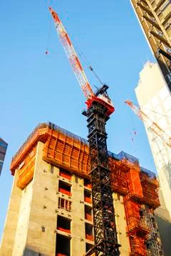 Skyscraper under construction with crane Stock Photos