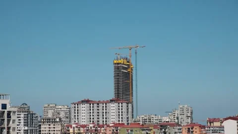 Skyscraper under construction with cranes against blue sky. Construction site of Stock Footage 281684017