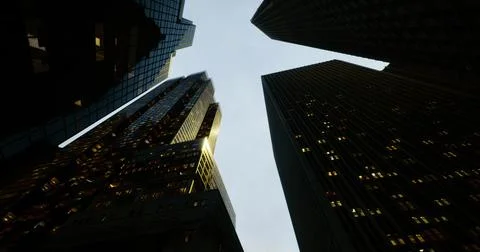 Skyscraper view at dusk showcasing urban architecture and city lights Stock Illustration