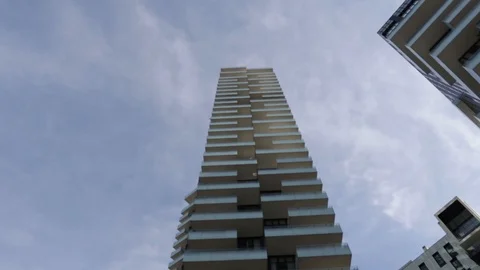 Skyscraper with white balconies panning down Stock Footage 104369935