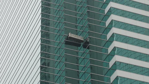Skyscraper window cleaners in a cradle Stock Footage 280348493