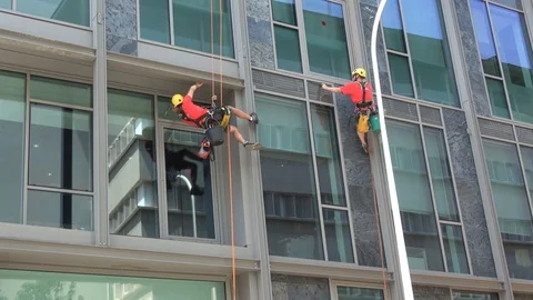 Skyscraper windows cleaning acrobatic worker Stock Footage 111812020