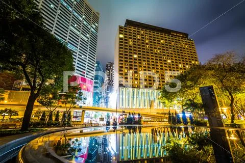 Skyscrapers and a fountain at Victoria Park at night, in Causeway Bay, Hong K Stock Photos