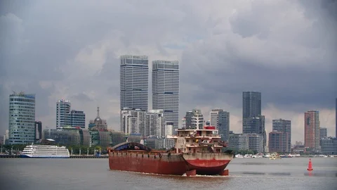 Skyscrapers and a ship floating on the river in Shanghai by day Stock Footage 99472720